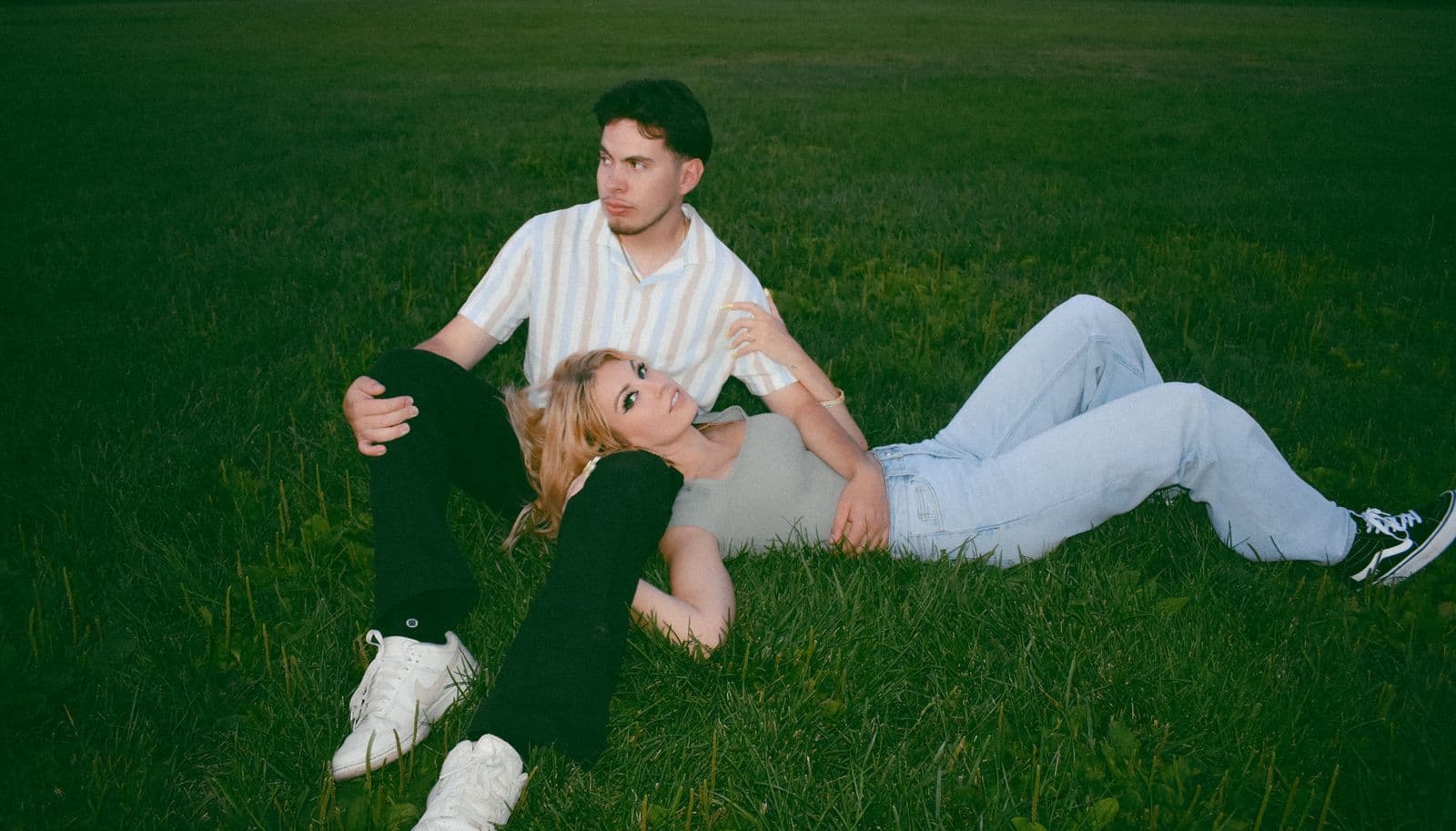 A couple lying together on the grass during an outdoor session in Las Vegas, NV