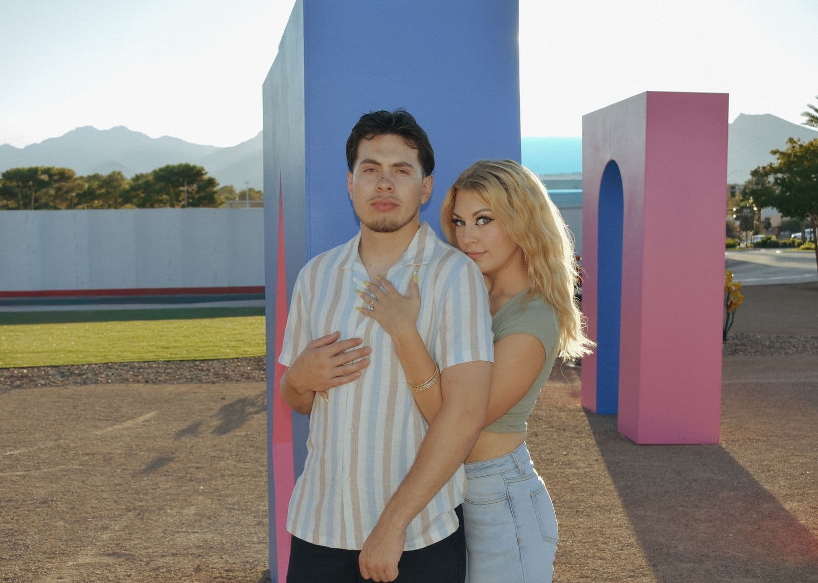 A couple photographed among pink and blue painted arches in Las Vegas, NV