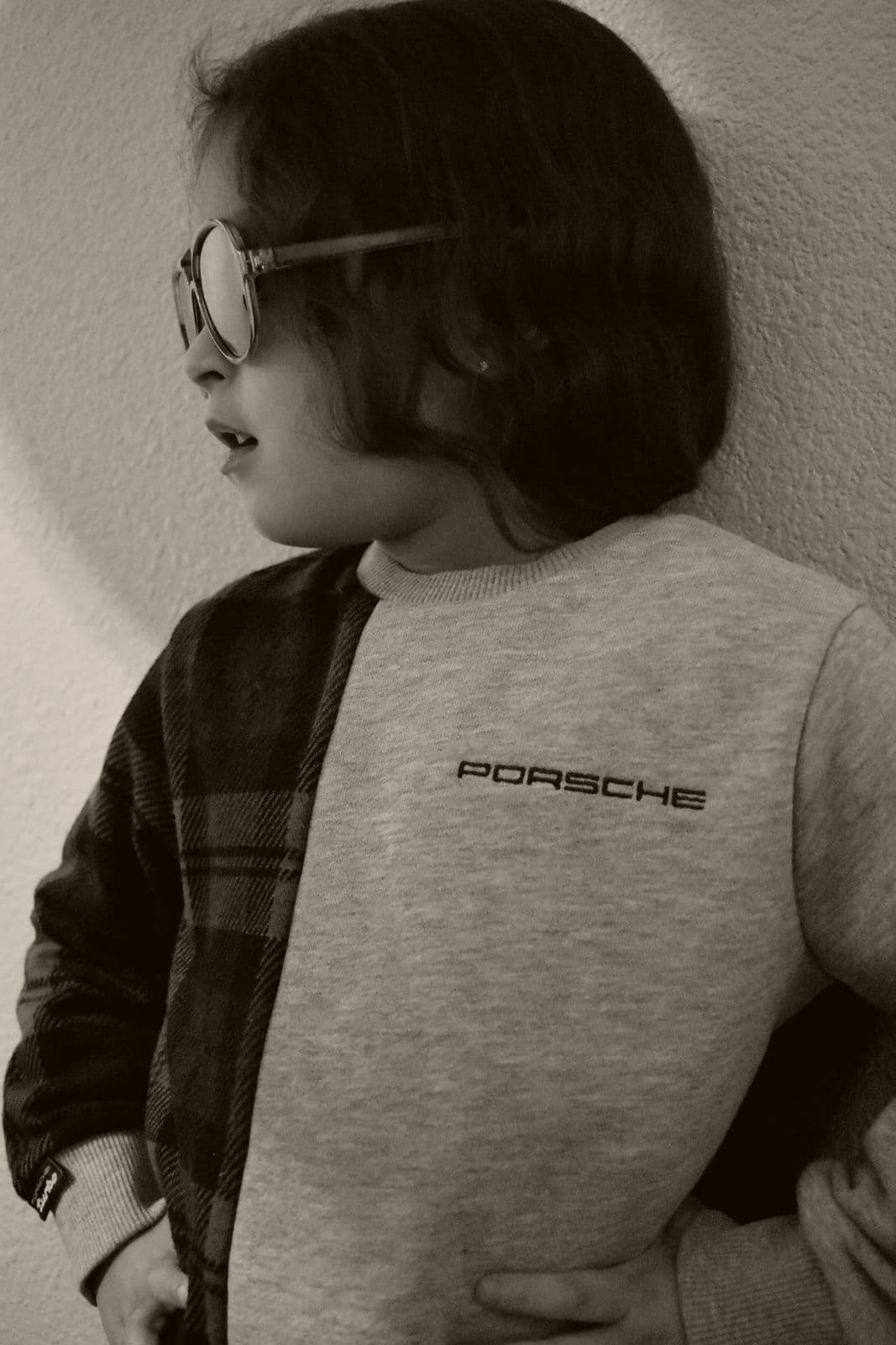 A moody indoor portrait of a young boy in a plaid jacket during a Las Vegas, NV family session
