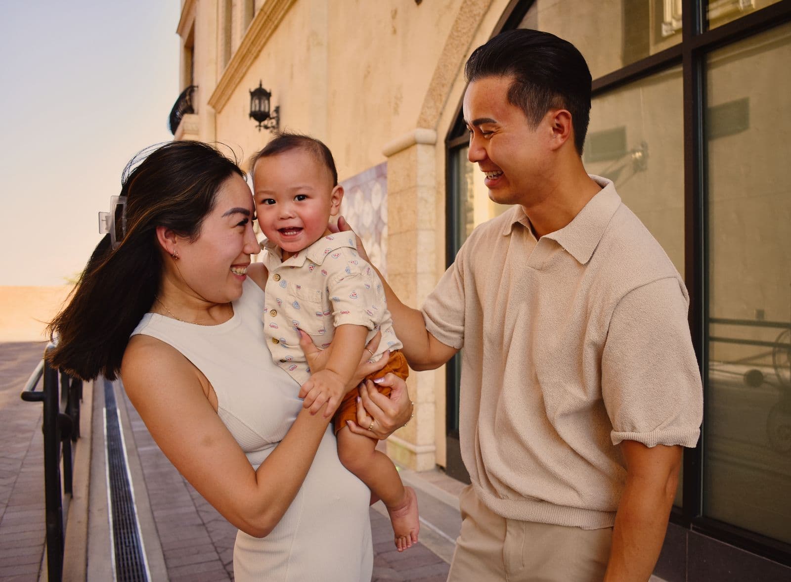 A family of three with their baby at a railing during a sunset session in Las Vegas, NV
