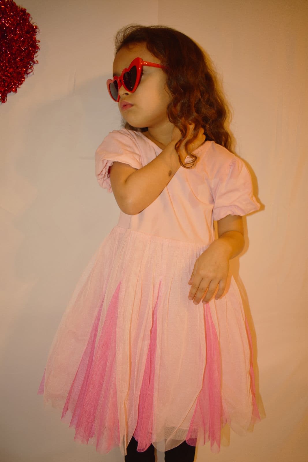 A young girl in a pink tulle dress photographed indoors during a Las Vegas, NV family session