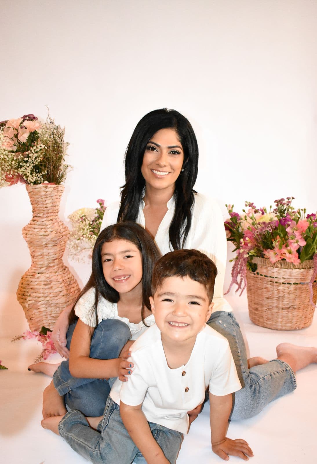 A mother laughing with her young son and daughter during a studio family session in Las Vegas, NV