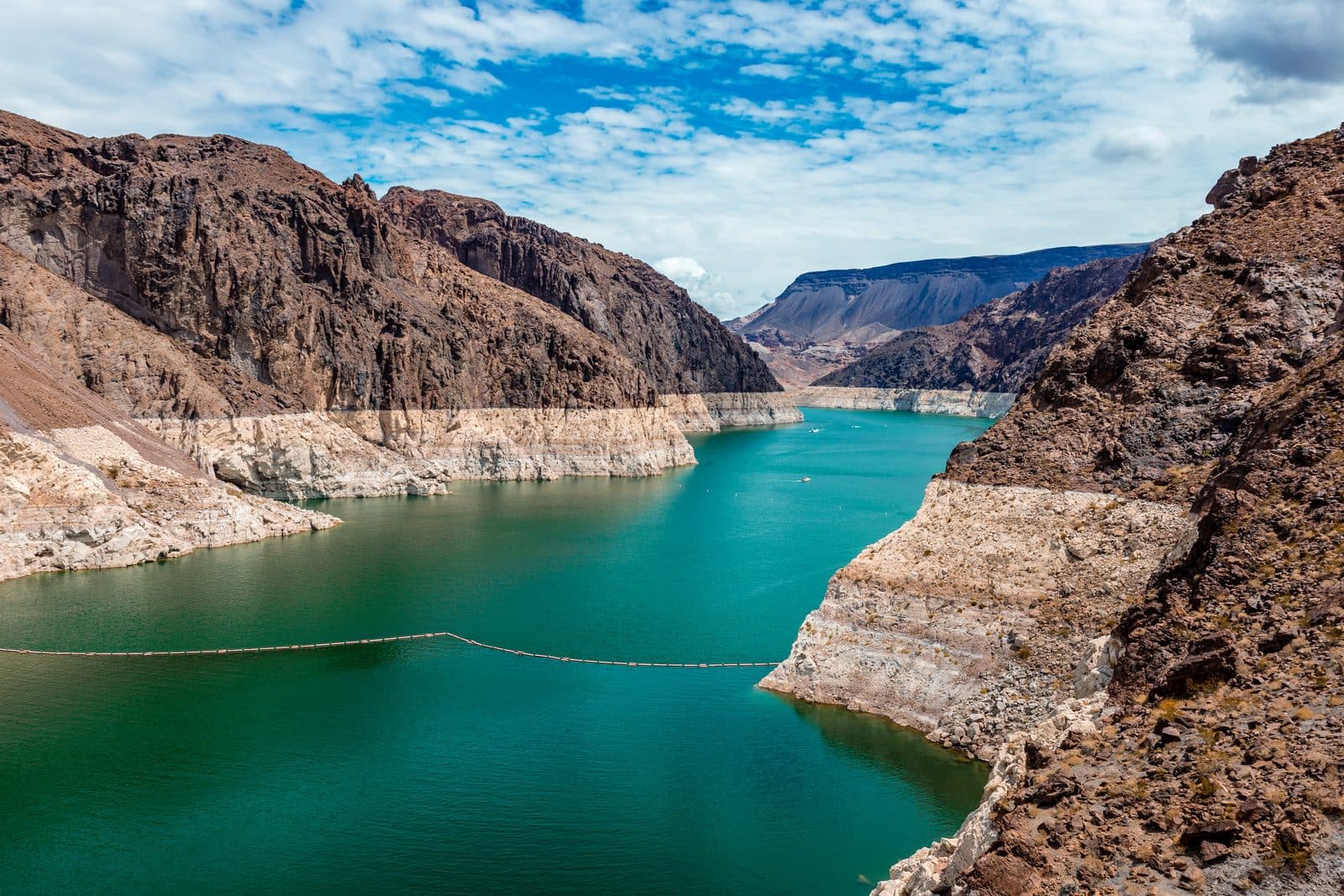 The receded turquoise water of Lake Mead in the Black Canyon of the Colorado River, with the white mineral bathtub ring left on the canyon walls above it